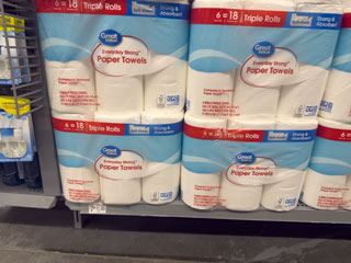 Paper towel packs stacked in shelf